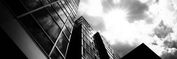 low-angle-grayscale-shot-business-buildings-with-cloudy-sky-background_11zon_11zon